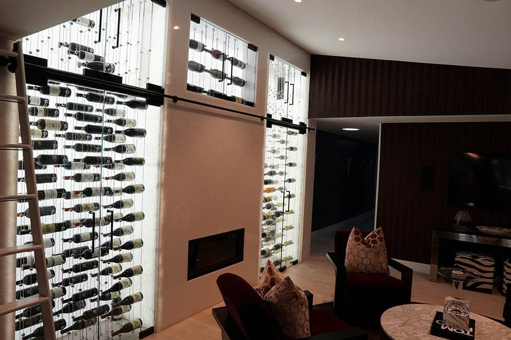 Wine cellar construction design with upper cable wine racking and lower wine rack columns